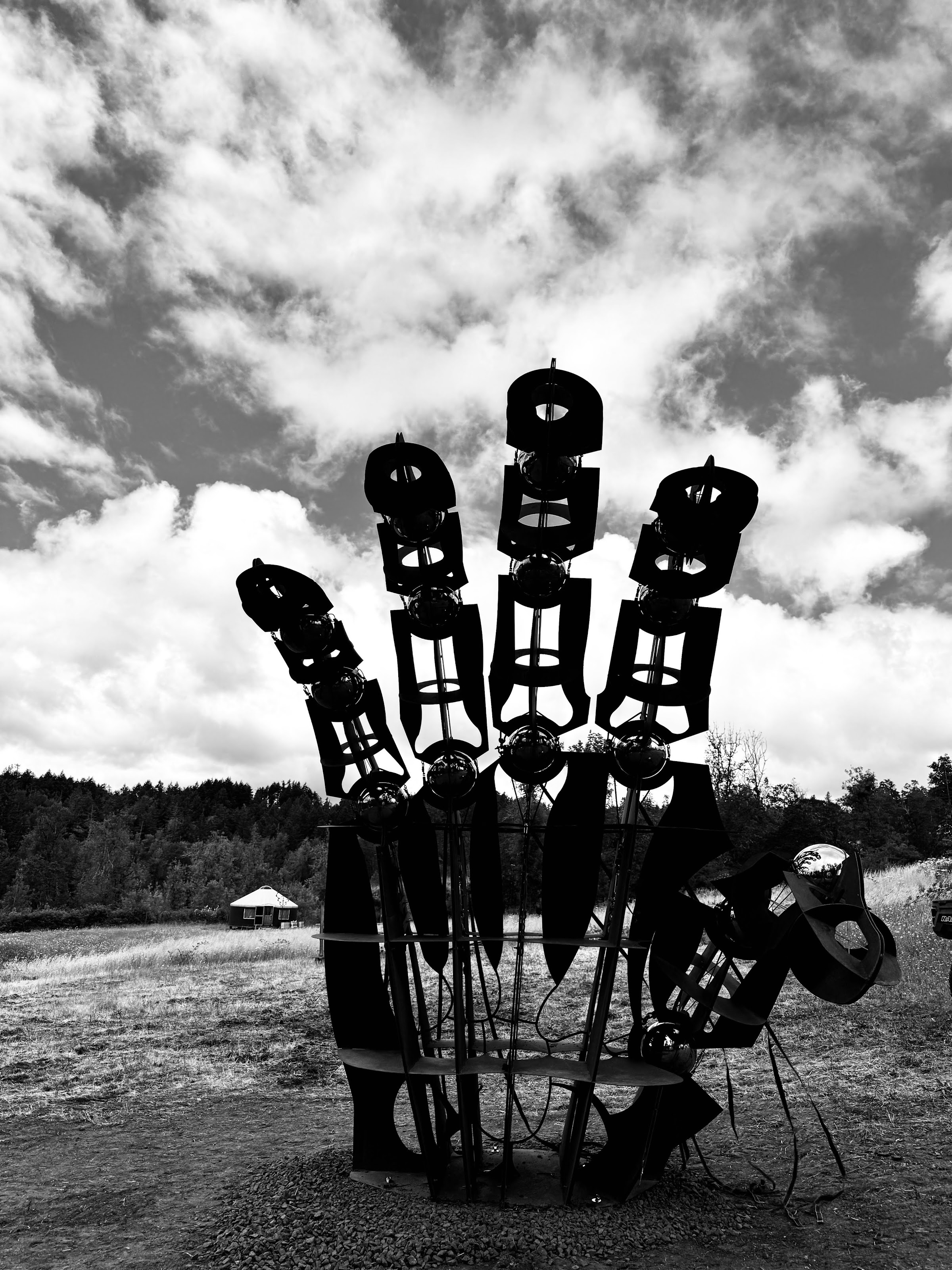 Awakening's hand, sculpture by Ryan Elmendorf and Nick Geurts, silhouetted against the sky